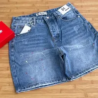 Men's Trendy Distressed Blue Denim Shorts with Artistic Paint Splatter Design - Stylish Casual Streetwear for Modern Youth - View 1