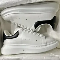Alexander McQueen White Leather Oversized Sole Sneakers with Black Suede Heel Tab - Unisex Designer Trainers for Men & Women - View 3