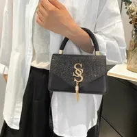 Women's Sparkling Black Glitter Top Handle Handbag – Chic Gold 'SS' Embellishment & Tassel Charm, Stylish Shoulder Bag - View 1