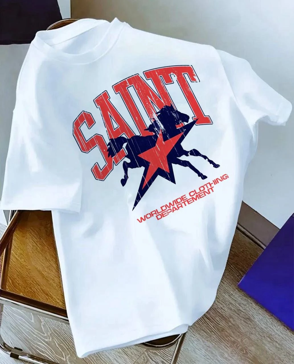 Unisex Trendy White "SAINT" Graphic T-Shirt with Horse & Star Print – Casual Everyday Streetwear Tee for Men & Women