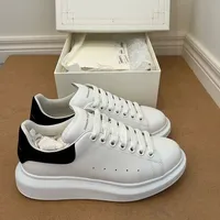 Alexander McQueen White Leather Oversized Sole Sneakers with Black Suede Heel Tab - Unisex Designer Trainers for Men & Women - View 1