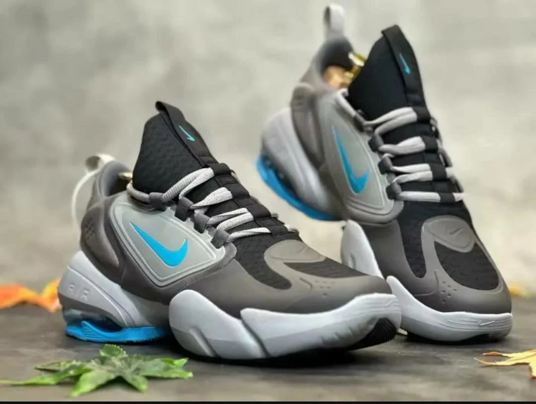 Nike Air Max Alpha Savage sneakers in a grey colorway with blue accents